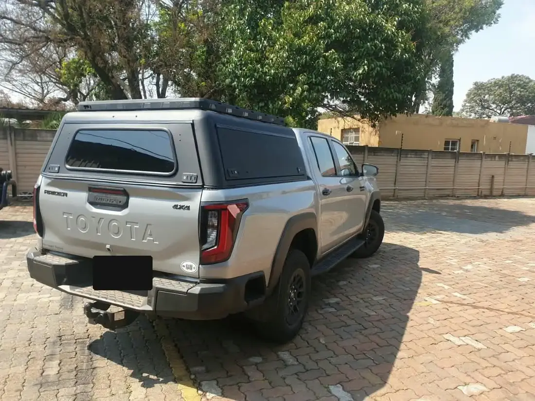 Matte black Veld Armour steel canopy with roof rack on a Toyota Hilux double cab