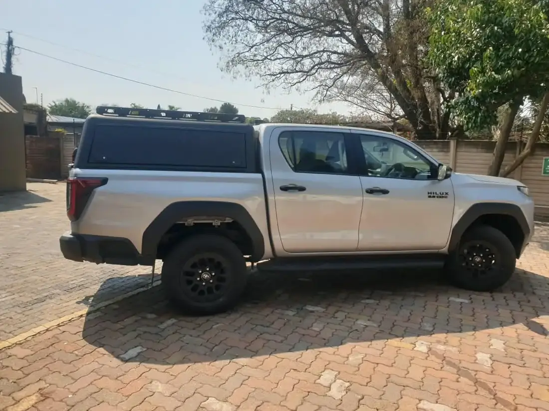 Side view of a Veld Armour steel canopy on a silver Toyota Hilux double cab