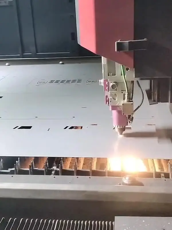 CNC laser cutting canopy panels from a steel sheet, sparks under the cut